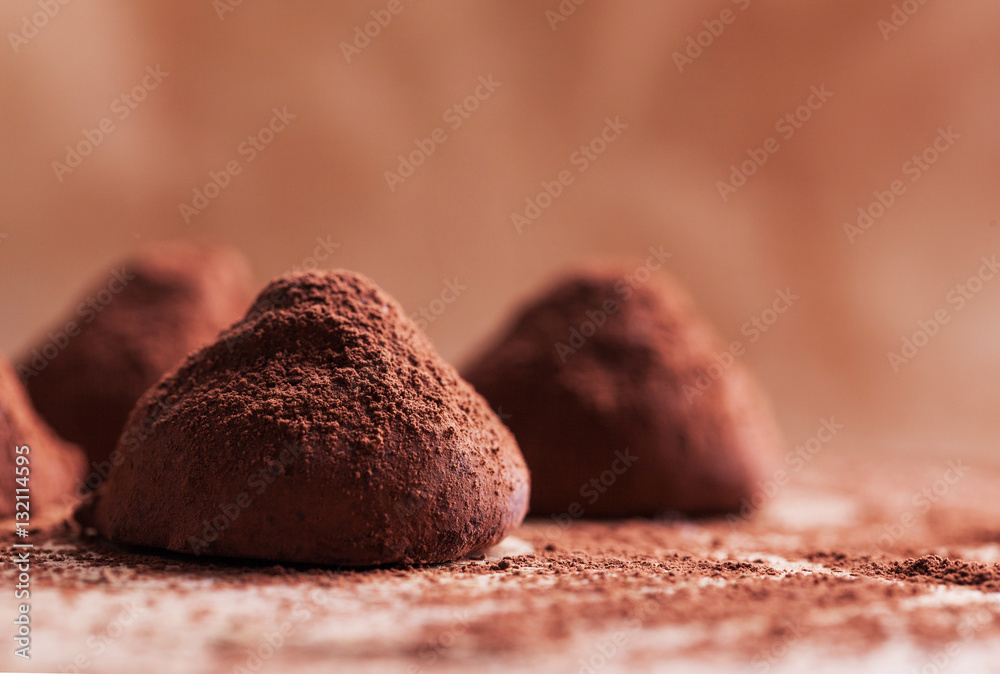 Chocolate truffles with sweet cream inside on the wooden background Chocolate truffles with sweet cream inside on the wooden background