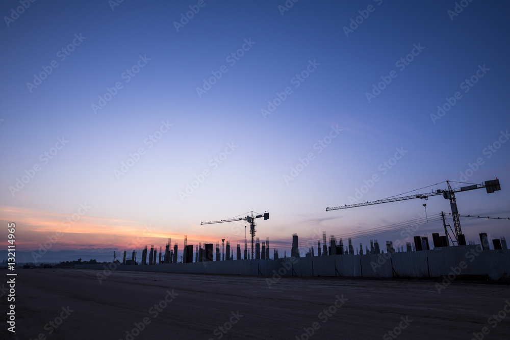 construction cranes and building at the morning sunrise