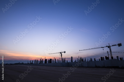 construction cranes and building at the morning sunrise