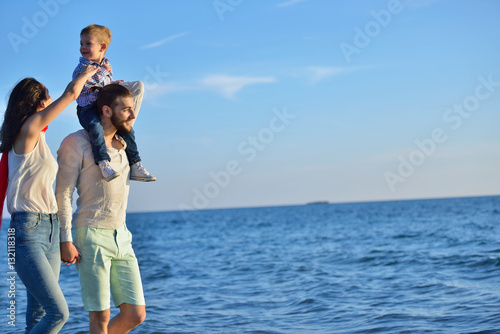 happy young family have fun on beach run and jump at sunset © FS-Stock