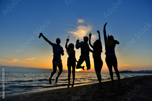 Fototapeta Naklejka Na Ścianę i Meble -  group of happy young people dancing at the beach on beautiful summer sunset