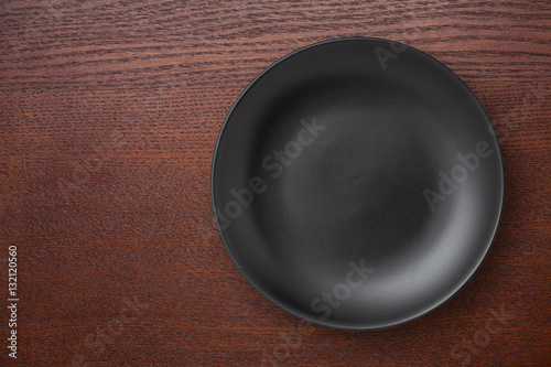 Top view of empty plate on the wooden table