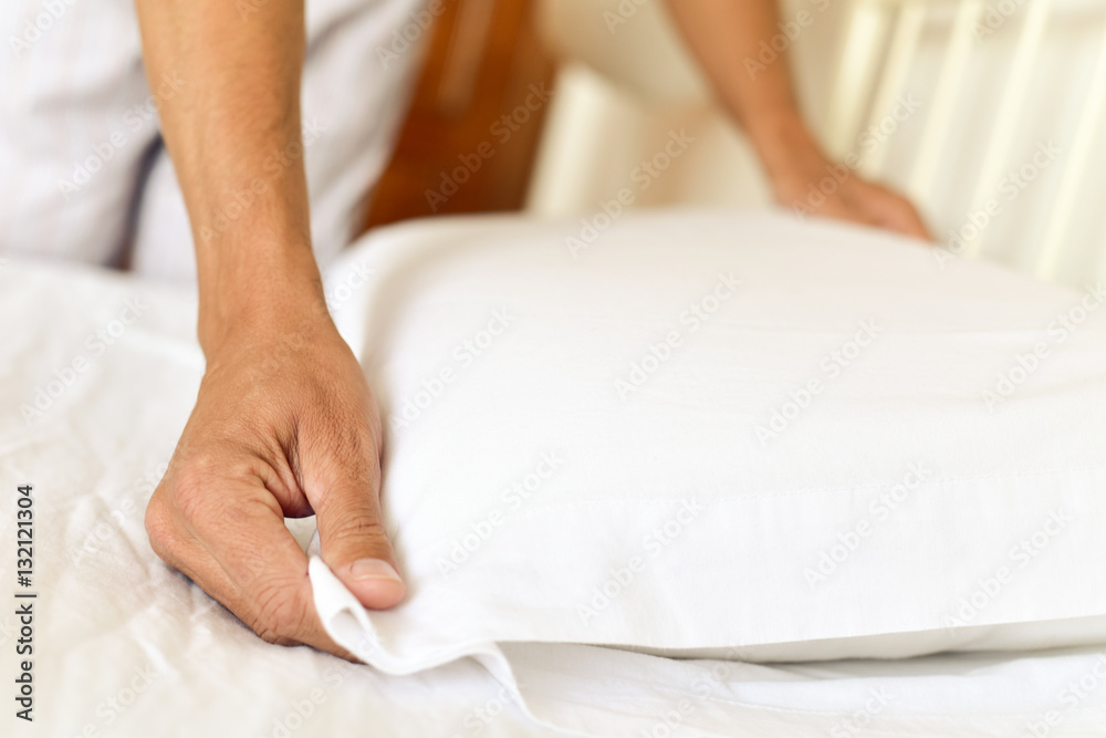 young man making the bed young man making the bed