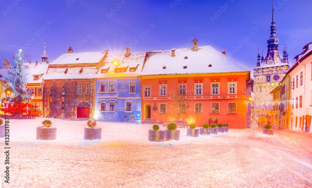 Naklejka premium Christmas market and decorations tree in the main center of Sighisoara town, in winter season, Romania