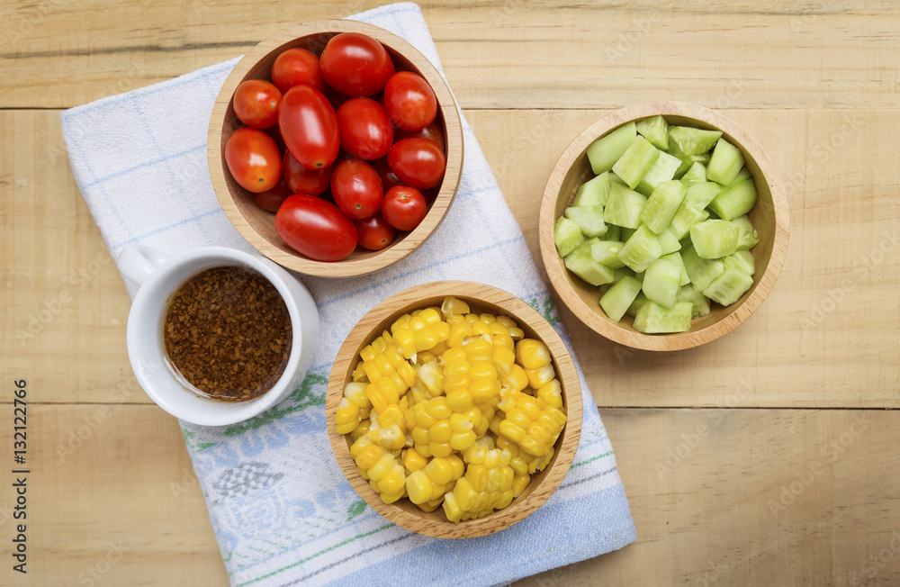 Fresh vegetable in wooden bowl with salad dressing in white cup, healthy food concept Fresh vegetable in wooden bowl with salad dressing in white cup, healthy food concept