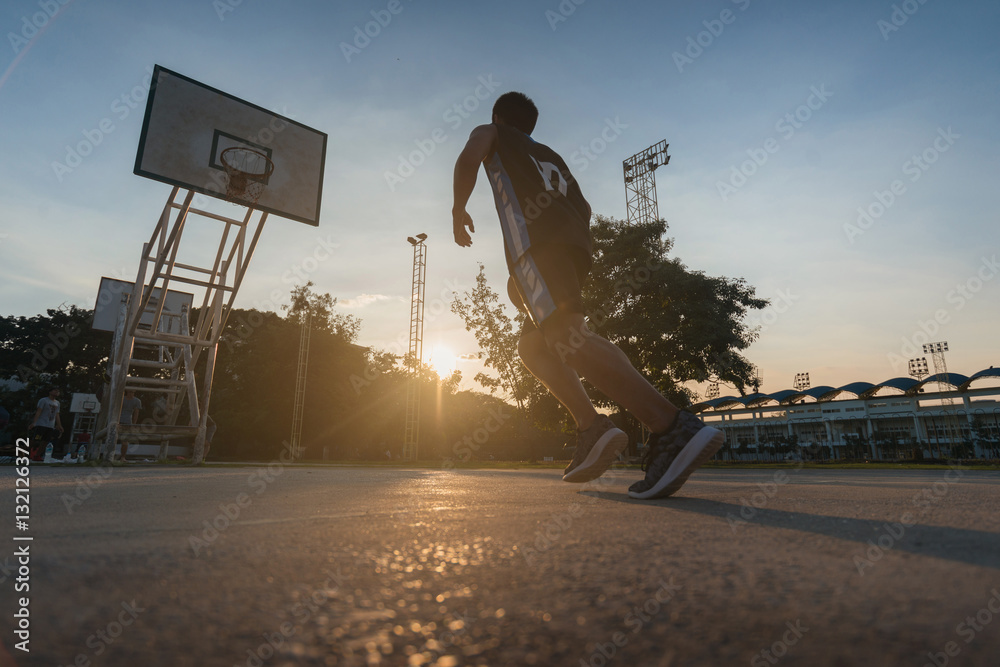 Fototapeta premium Basketball players playing basketball outdoor.
