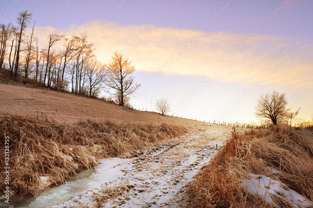 Sunset and frozen land, mountain landscape Sunset and frozen land, mountain landscape