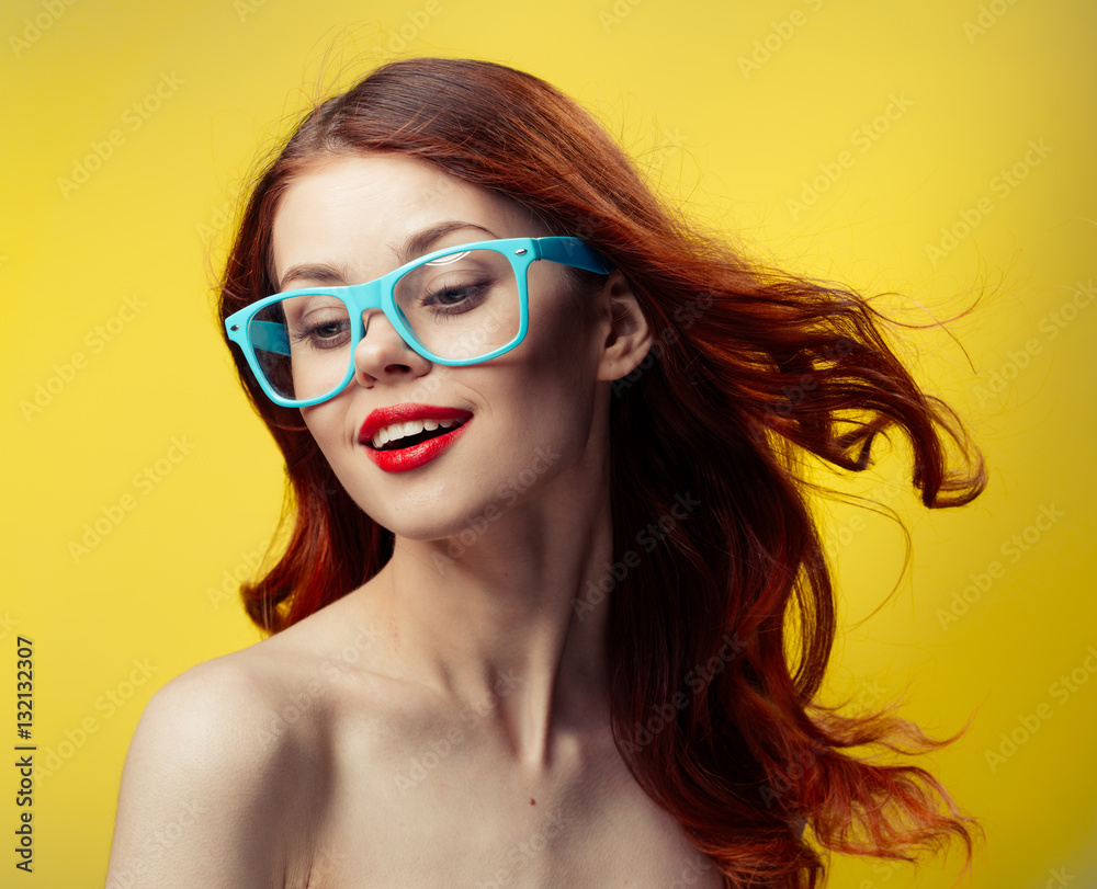 cheerful woman with red lips on yellow background, glasses with blue rim cheerful woman with red lips on yellow background, glasses with blue rim