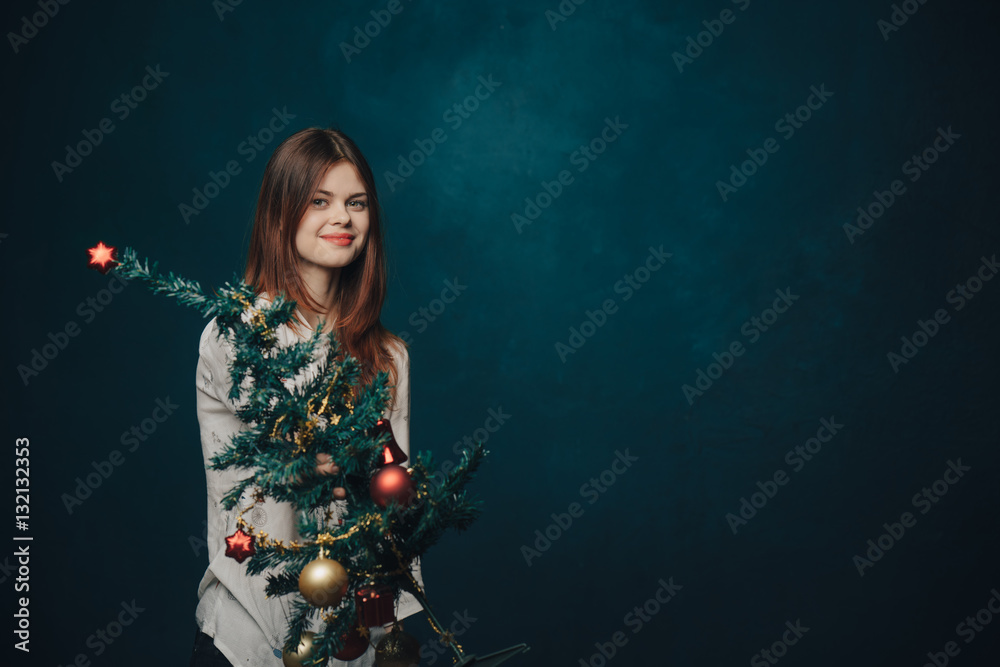 woman, tree with toys, holiday