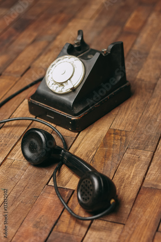 old black phone on a wooden background, retro