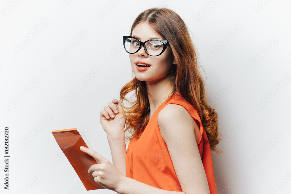 beautiful woman with glasses, bright dress, orange notebook beautiful woman with glasses, bright dress, orange notebook