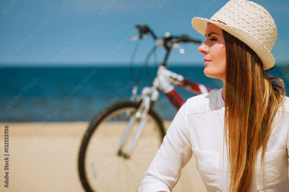 Girl with bike on beach.