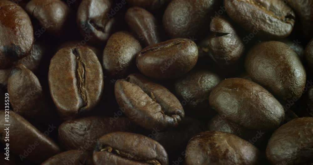 Macro shot of a roasted coffee bean. close up of high-quality arabic coffee with, produced in Brazil, Colombia and Venezuela. Macro shot of a roasted coffee bean. close up of high-quality arabic coffee with, produced in Brazil, Colombia and Venezuela.