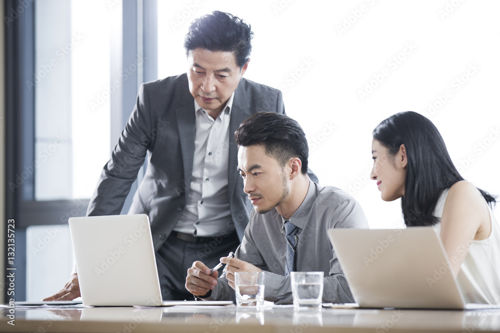 Business people talking in meeting room Business people talking in meeting room