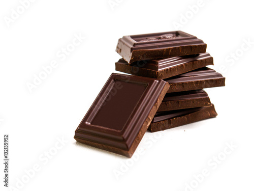 broken bar of dark chocolate on isolated white background