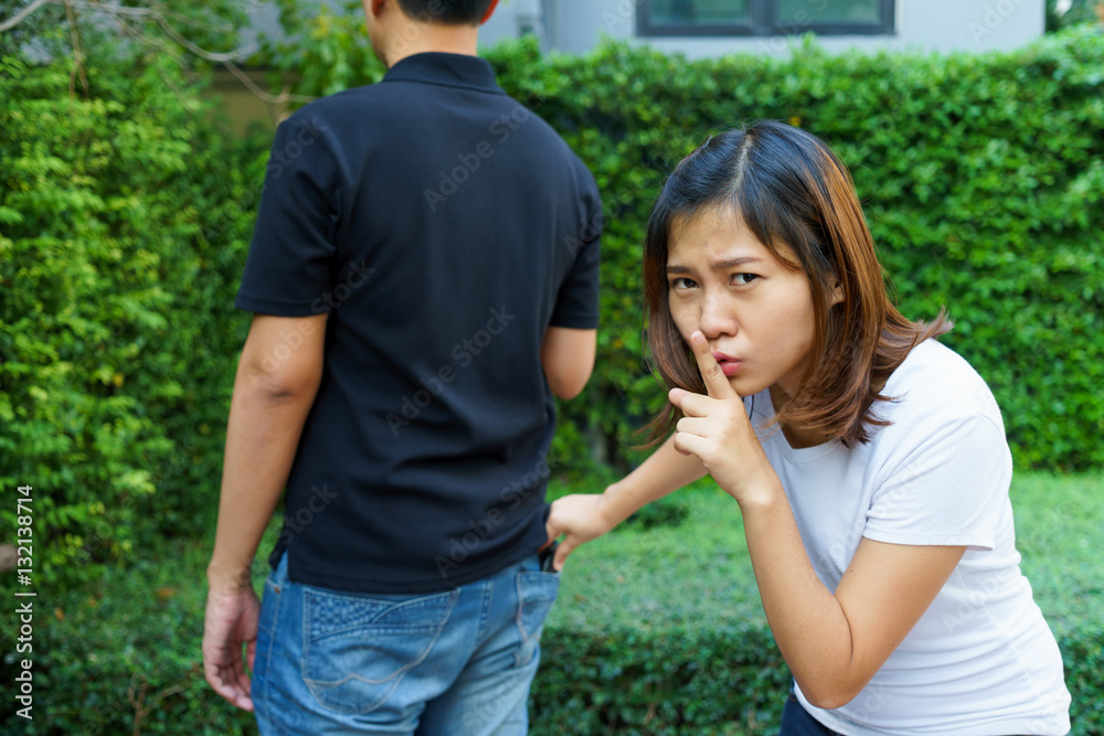 Female pickpocket stealing a wallet from behind pocket on jeans Female pickpocket stealing a wallet from behind pocket on jeans