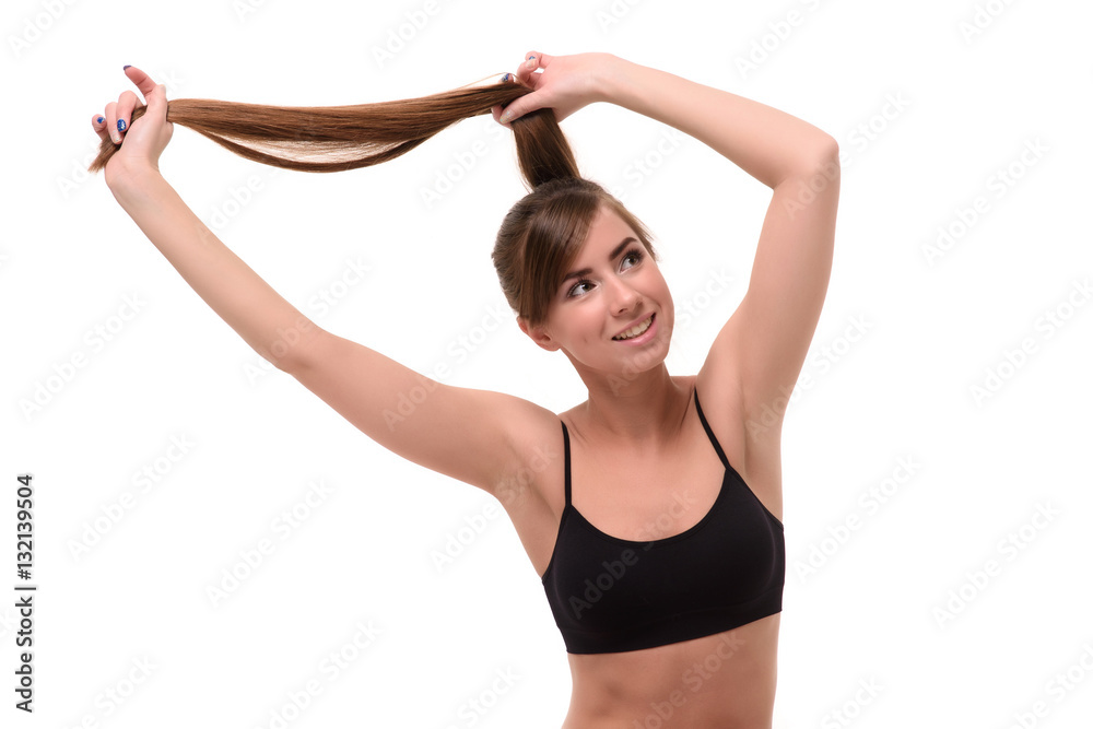 happy young woman holding hairs with her hands isolate
