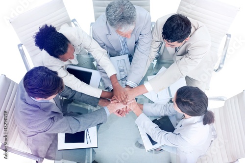 Cheerful international business people with hands together  photo