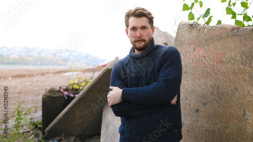 Handsome bearded man on the background of the river