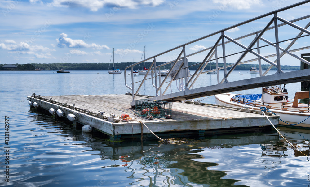 Floating dock with a boat to the side in the summertime at Searsport, Maine.