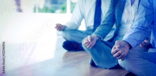 Close up view of business people doing yoga 