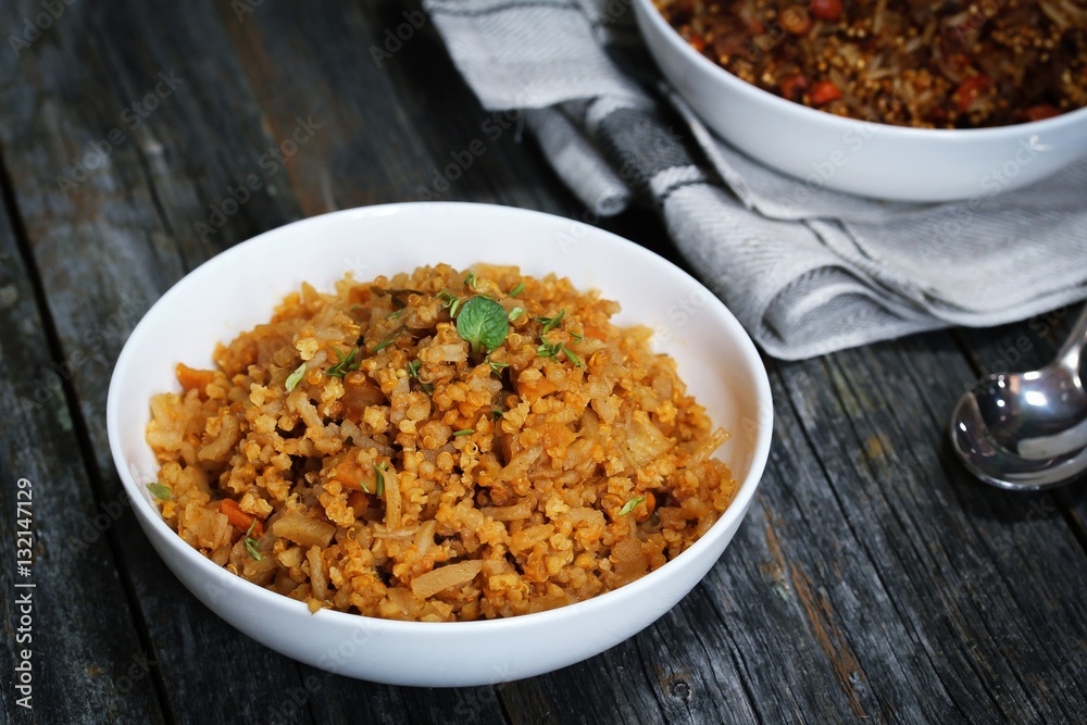 Spicy Quinoa Pilaf served in a bowl on dark wooden background Spicy Quinoa Pilaf served in a bowl on dark wooden background