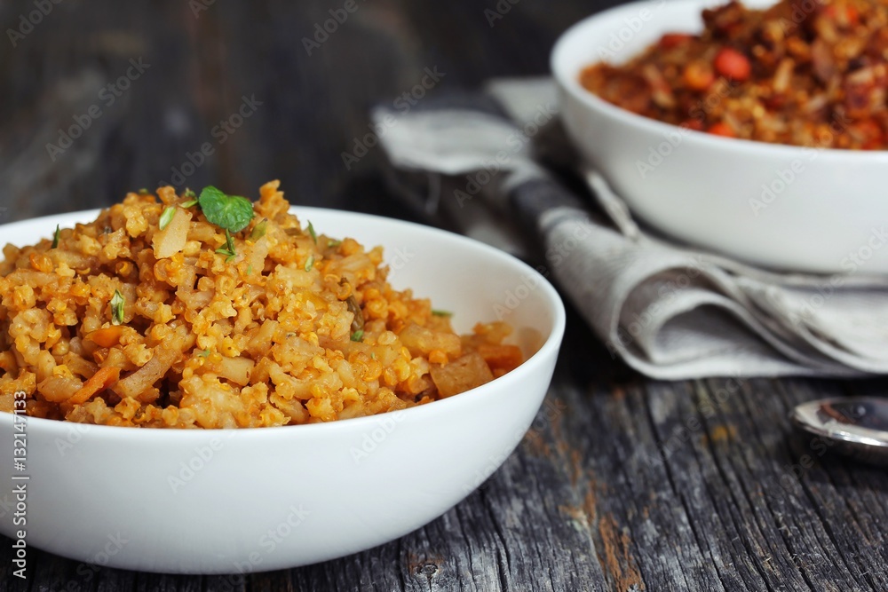 Spicy Quinoa Pilaf served in a bowl on dark wooden background Spicy Quinoa Pilaf served in a bowl on dark wooden background