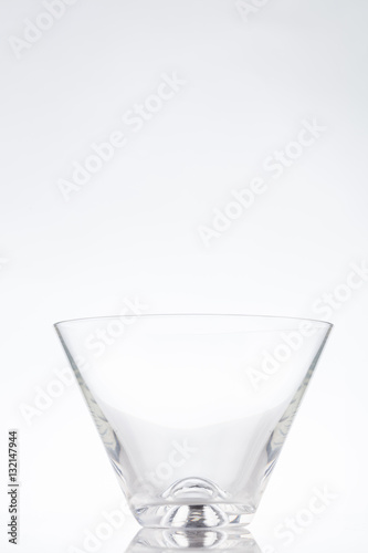 Triangle clear cocktail glass on a white background