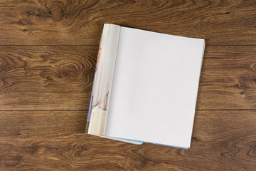 Mock-up magazine or catalog on wooden table. Blank page or notepad on wood background. Blank page or notepad for mockups or simulations.