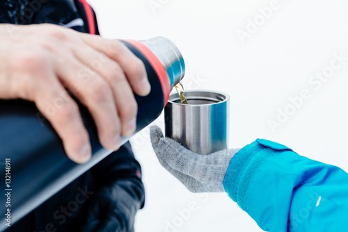 Man pouring hot tea from a thermos