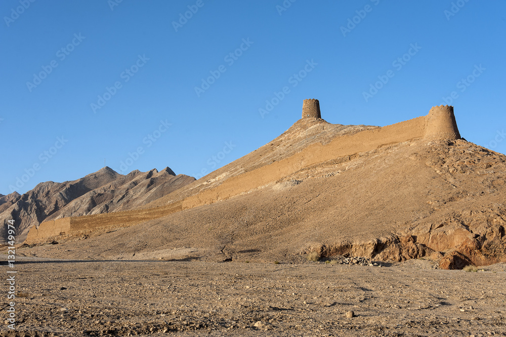 Iran, Anarak: Skyline of the desert city. It is surrounded by ruins of an old wall and three watchtowers, which were built about 100 years ago to keep Hossein Kashi and his bandit gang out. Iran, Anarak: Skyline of the desert city. It is surrounded by ruins of an old wall and three watchtowers, which were built about 100 years ago to keep Hossein Kashi and his bandit gang out.