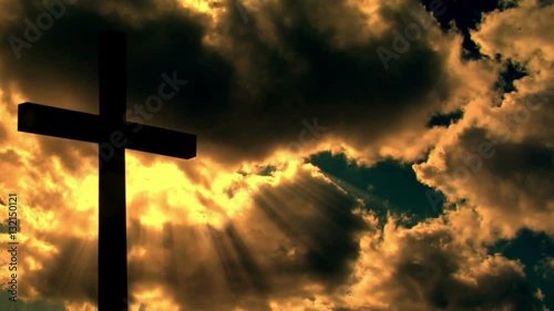 A cross silhouette in front of time lapse cloud and a warm sunlight 10696

