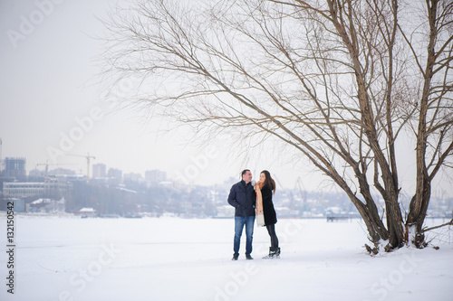 happy couple in love walking in the winter