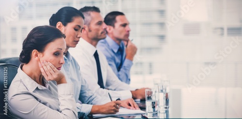 Businesswoman getting bored while attending presentation photo