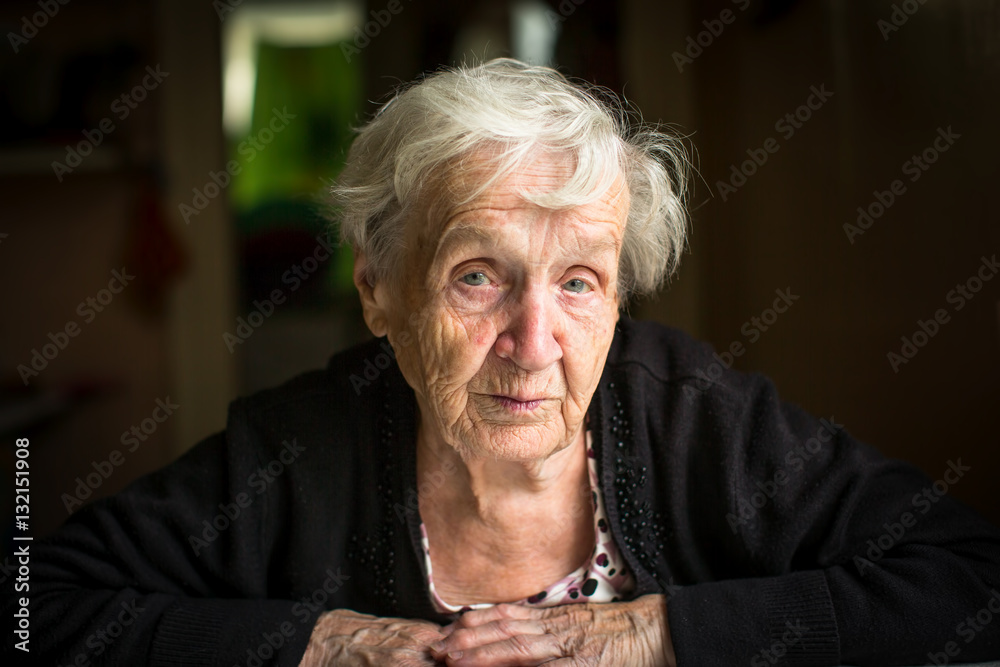 Elderly woman portrait, sitting in the house. Grandmother, old lady, pensioner. Elderly woman portrait, sitting in the house. Grandmother, old lady, pensioner.