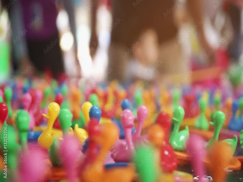 Colorful Toy ducks floating around on water
