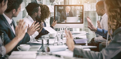 Business people looking at screen during video conference photo