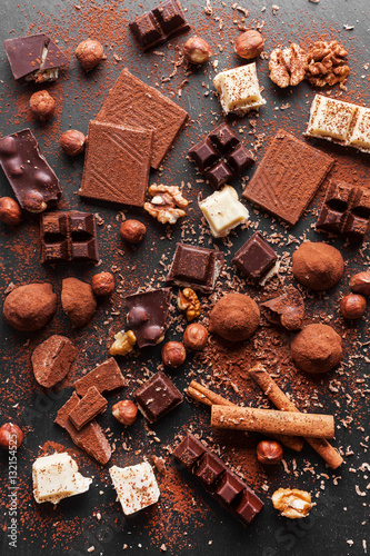 Variety of sweet homemade chocolate pralines on wooden background