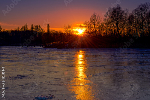 Frozen river in winter evening