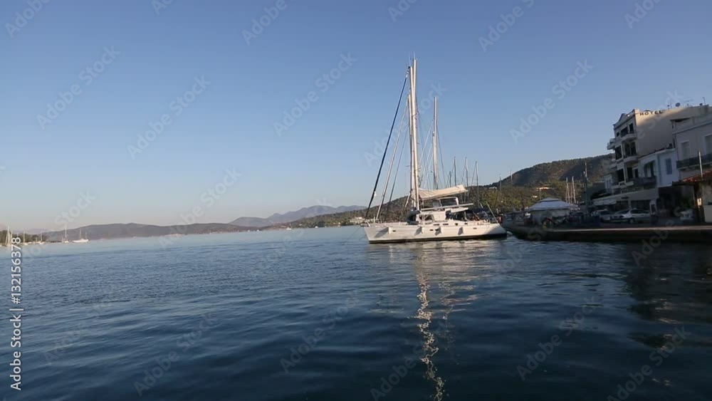 Passage of the sailing vessel along the coast of Poros island, Aegean Sea. Passage of the sailing vessel along the coast of Poros island, Aegean Sea.
