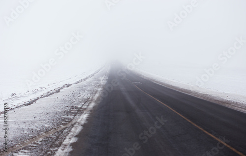 Snowstorm and poor visibility on the road  end is lost in the fog