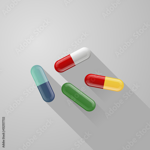 set of blue, red, white, green, yellow pills isolated on gray background with long shadow