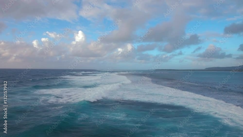 Aerial view of foamy waves of Indian Ocean rolling in lagoon on the coast of Mauritius Island Aerial view of foamy waves of Indian Ocean rolling in lagoon on the coast of Mauritius Island