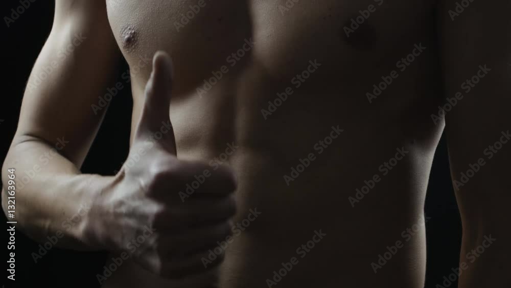 sports guy holding his hand over his stomach. Training Sit Ups sports guy holding his hand over his stomach. Training Sit Ups