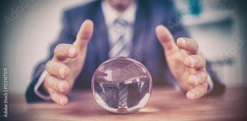 Businessman forecasting a crystal ball photo