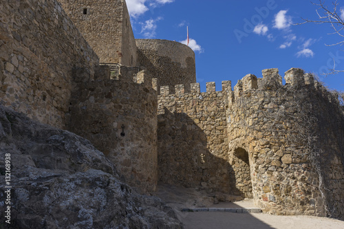 Stone walls of a medieval castle. Town of Consuegra in the provi
