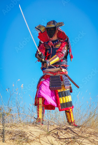 Samurai with sword on the sand. Men in samurai armour