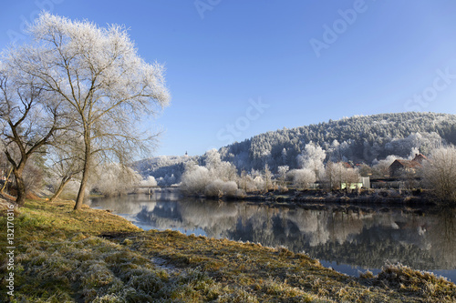 Fairytale snowy winter rural landscape with blue Sky in Bohemia, Czech Republic