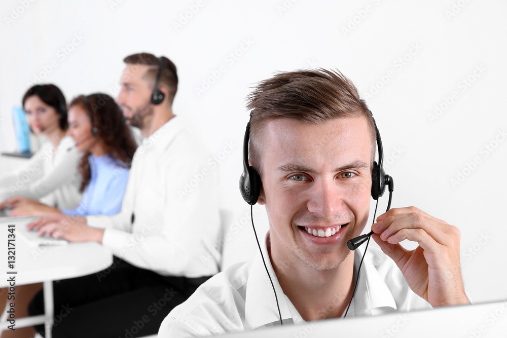 Young male technical support dispatcher working in office, closeup Young male technical support dispatcher working in office, closeup