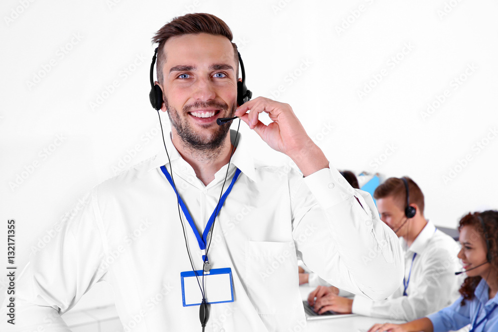Young male technical support dispatcher working in office, closeup Young male technical support dispatcher working in office, closeup